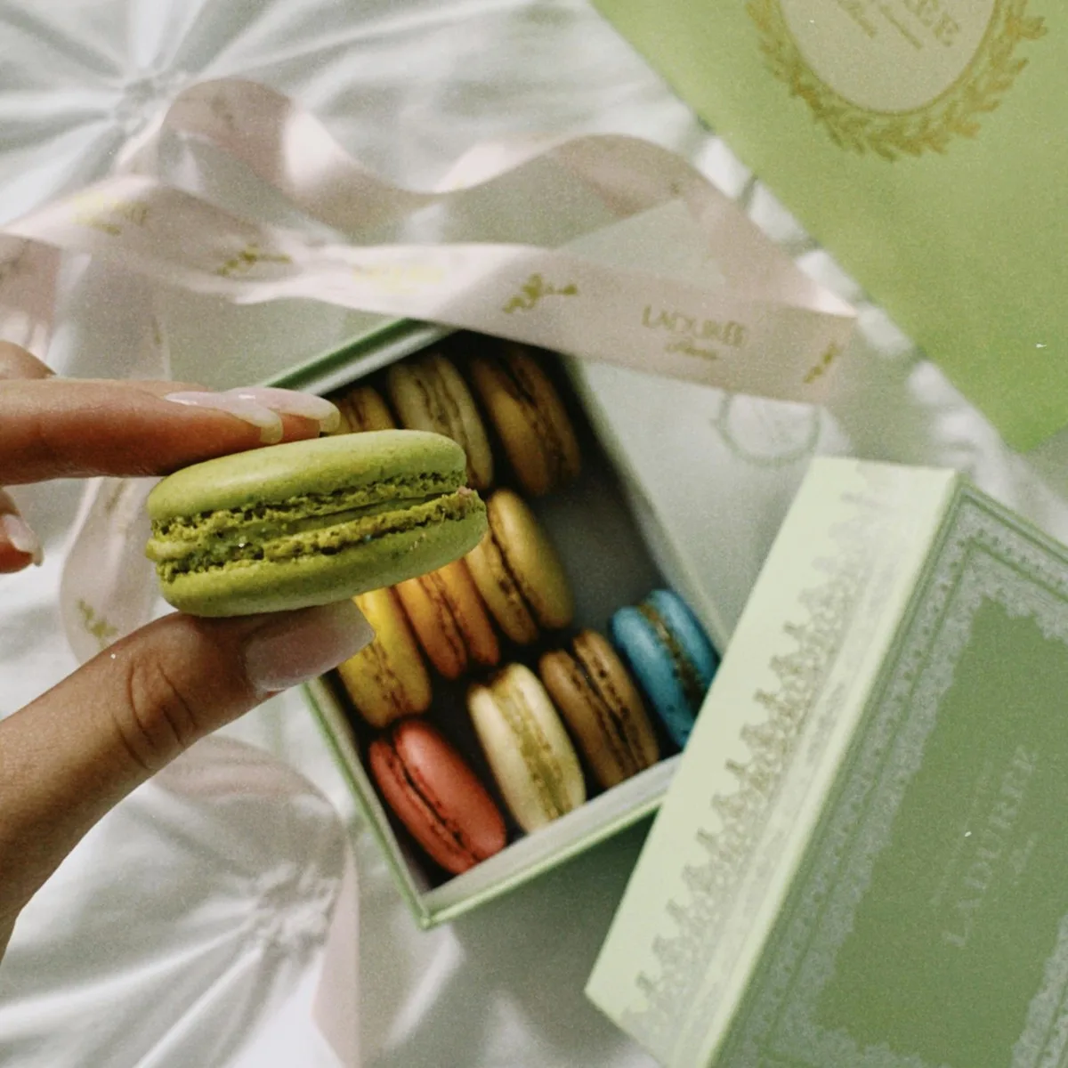 Bánh macaron trong hộp quà màu xanh lá