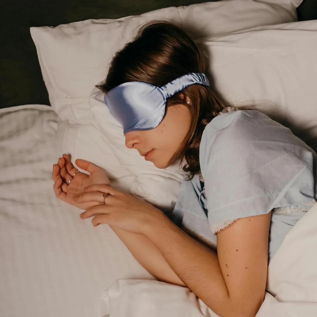 Cô gái nằm nghiêng ngủ ngon với bịt mắt lụa xanh