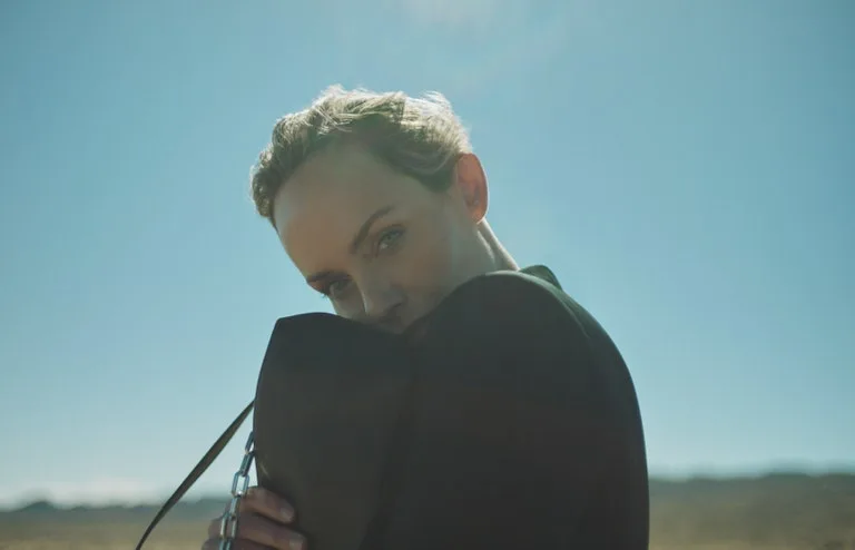 Amber Valletta holding a piece from collaborated collection between Karl Lagerfeld x Amber Valletta collection