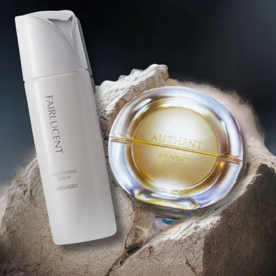Hình ảnh hai sản phẩm Menard Authent Cream và Menard Fairlucent Brightening Serum thắng giải tại ELLE Beauty Awards 2026.
