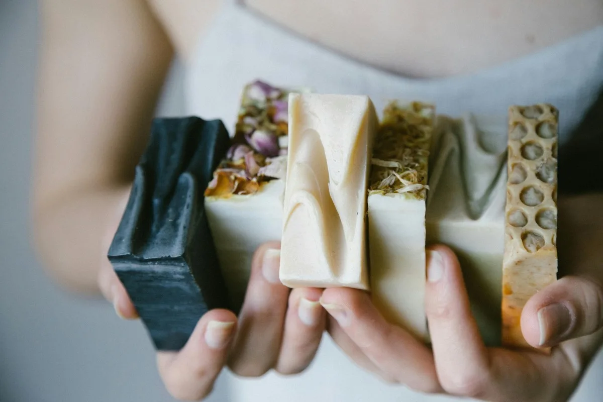 Cô gái cầm các bánh xà phòng có thiết kế tinh tế đặt vào tủ quần áo