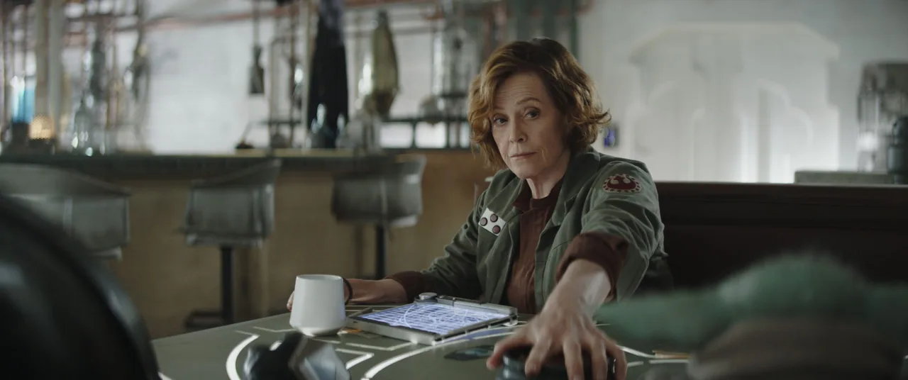 (L-R) Colonel Ward (Sigourney Weaver) and Grogu in Lucasfilm's THE MANDALORIAN and GROGU. Photo courtesy of Lucasfilm. © 2025 Lucasfilm Ltd™. All Rights Reserved.