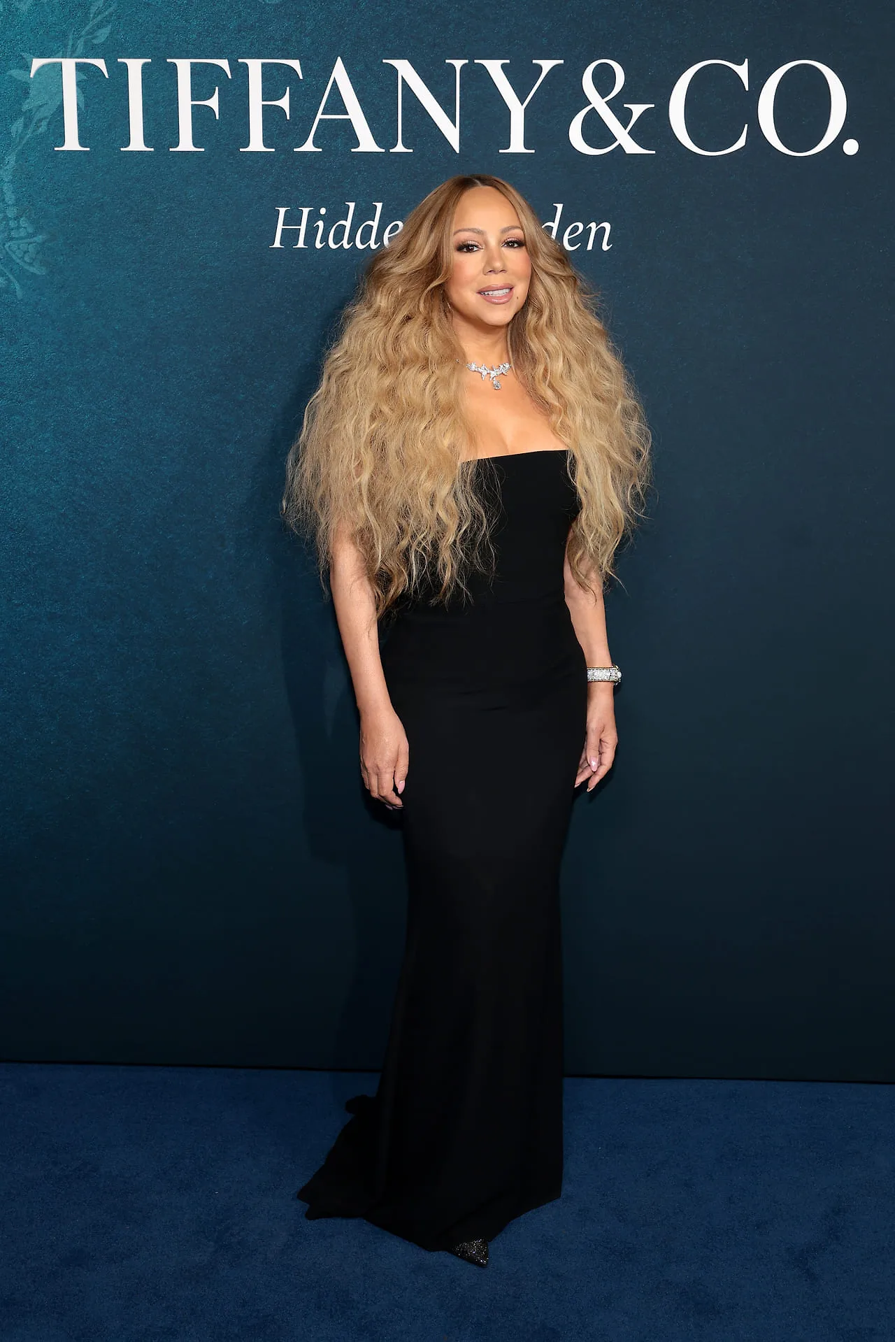 Mariah Carey: "Diva của những bản hit" khoe vẻ đẹp không tuổi trong chiếc đầm đen cúp ngực cổ điển, tôn vinh bộ trang sức kim cương lộng lẫy gồm vòng cổ hình bướm và vòng tay bản lớn cực kỳ xa hoa.