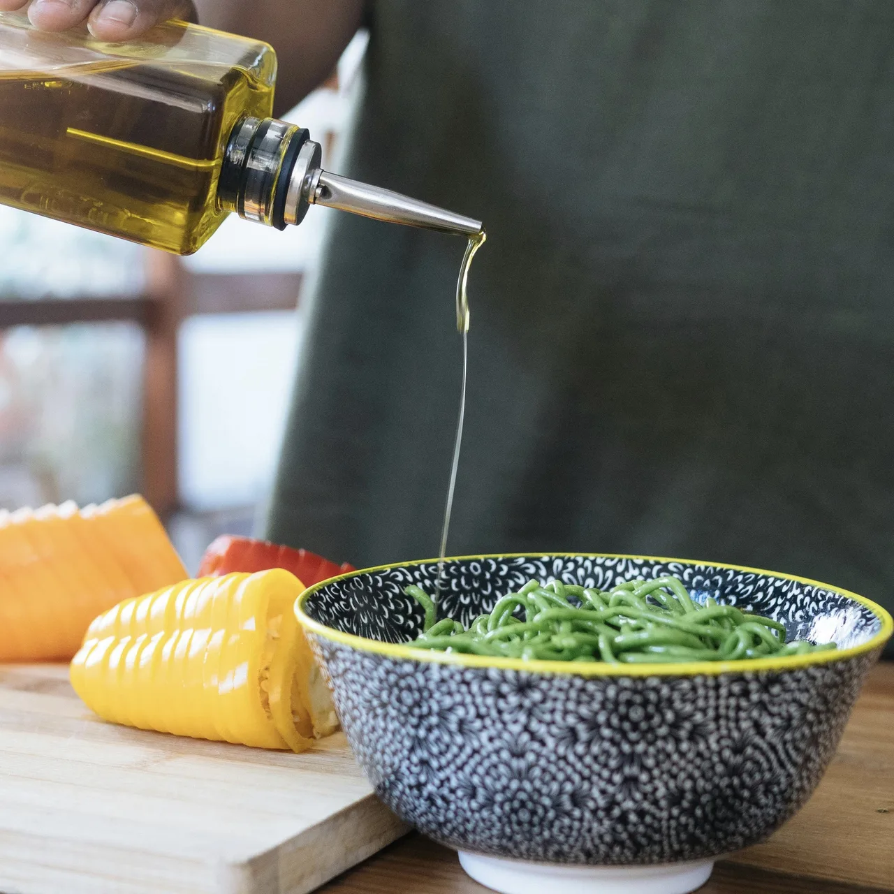 Dầu olive đen nguyên chất đang được rót lên món ăn.