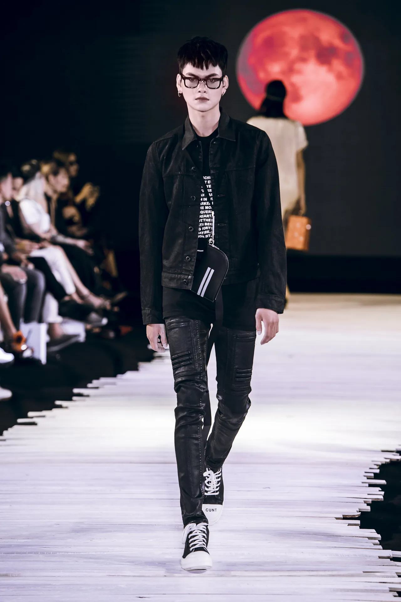 Người mẫu nam mặc áo denim và quần đen