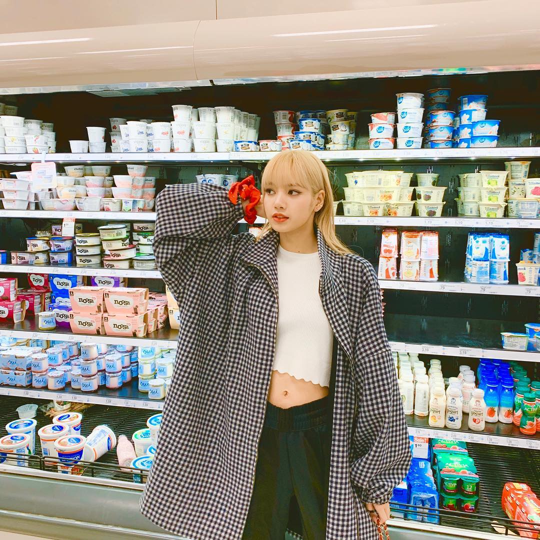 Lisa đeo vòng tay scrunchie màu đỏ đứng trong siêu thị