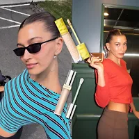 Hình ảnh Hailey Bieber với lớp trang điểm căng bóng để minh họa cho cách Hailey Bieber che khuyết điểm cho kiểu makeup ngày Hè.