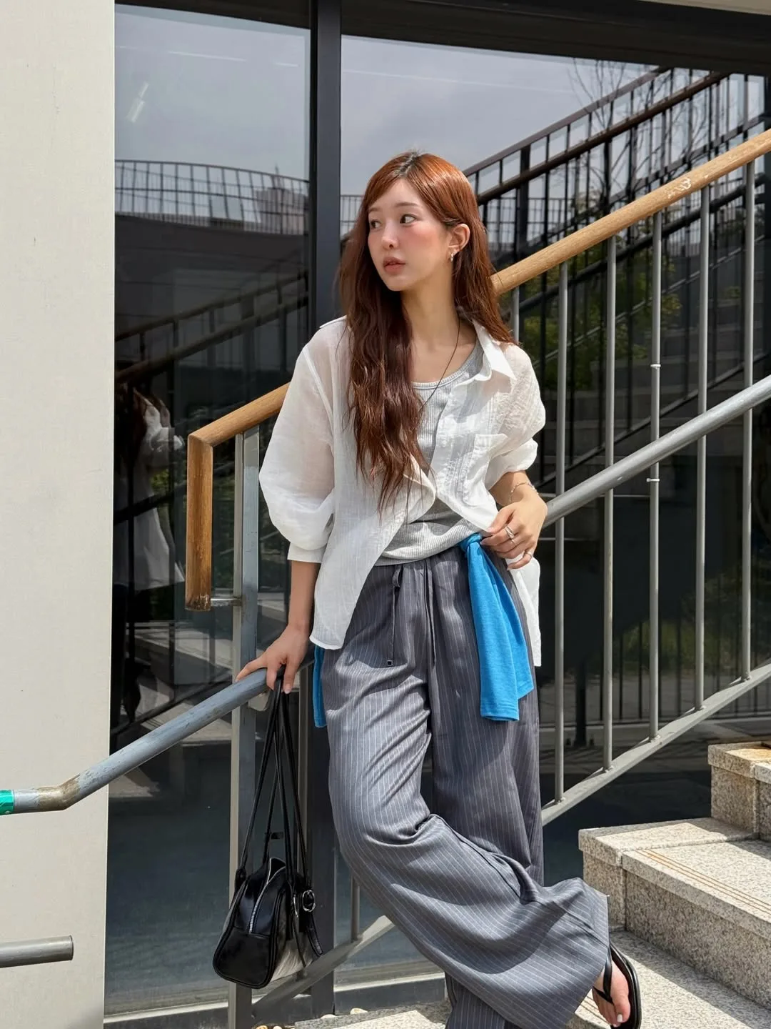 Phóng khoáng và thời thượng khi khoác hờ áo sơ mi oversized bên ngoài tank top gân.